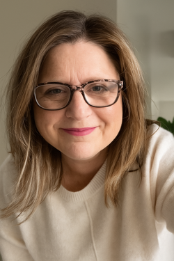 Professional headshot with warm expression